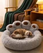 Cat sleeping curled up in The Burrow Nest cozy flannel pet bed