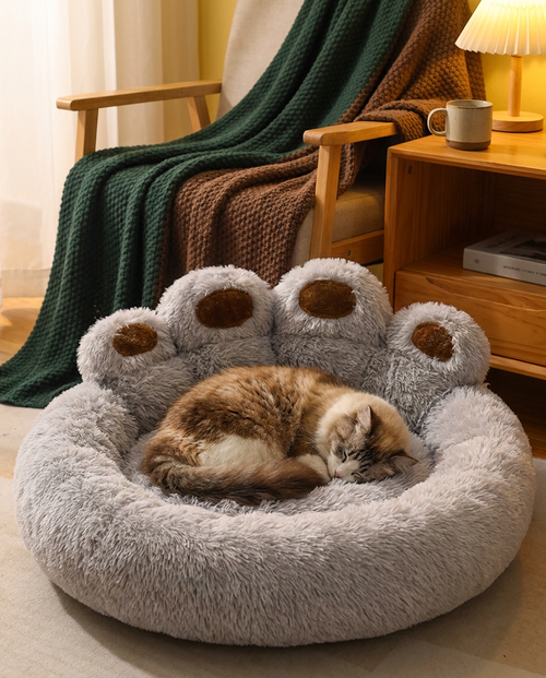 Cat sleeping curled up in The Burrow Nest cozy flannel pet bed